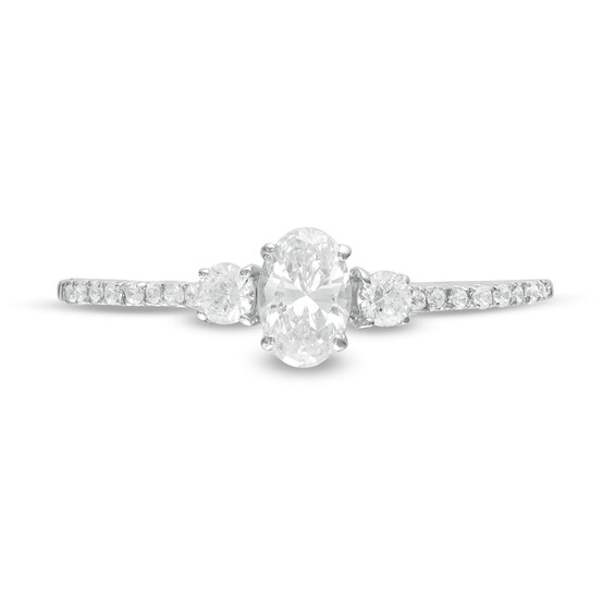 5/8 CT. T.w. Oval and Round Diamond Three Stone Engagement Ring in 14K White Gold