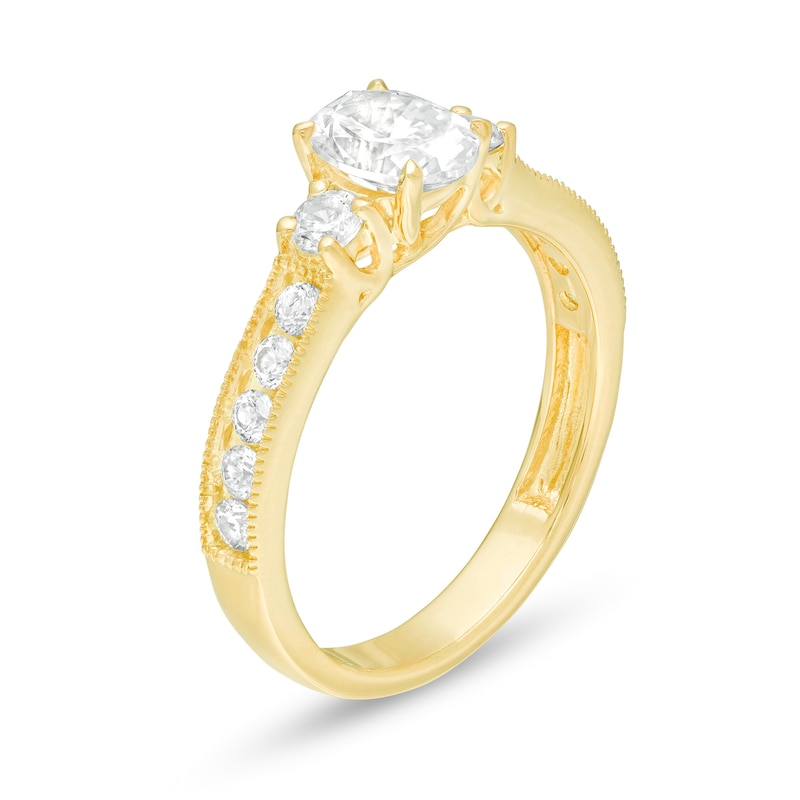 1-1/6 CT. T.W. Oval and Round Diamond Three Stone Engagement Ring in 14K Gold