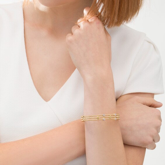 1/5 CT. T.w. Enhanced Yellow and White Diamond Station Triple Row Rope Bangle in Sterling Silver with 14K Gold Plate