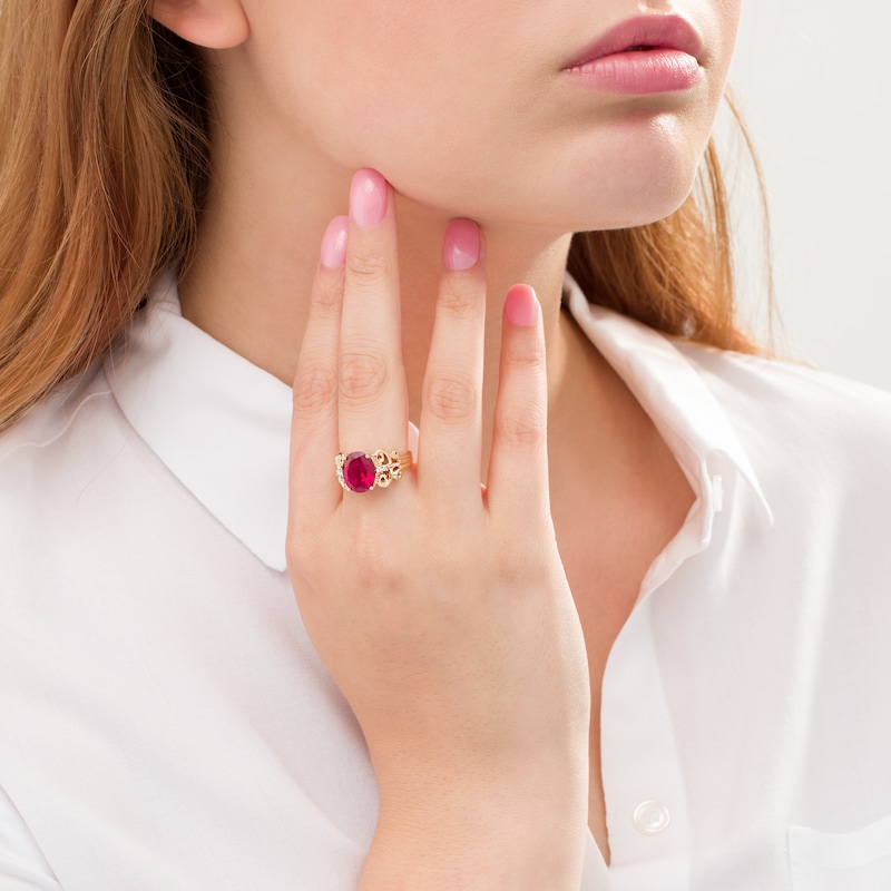 Oval Lab-Created Ruby and 1/20 CT. T.W. Diamond Vintage-Style Scroll Ring in 10K Gold