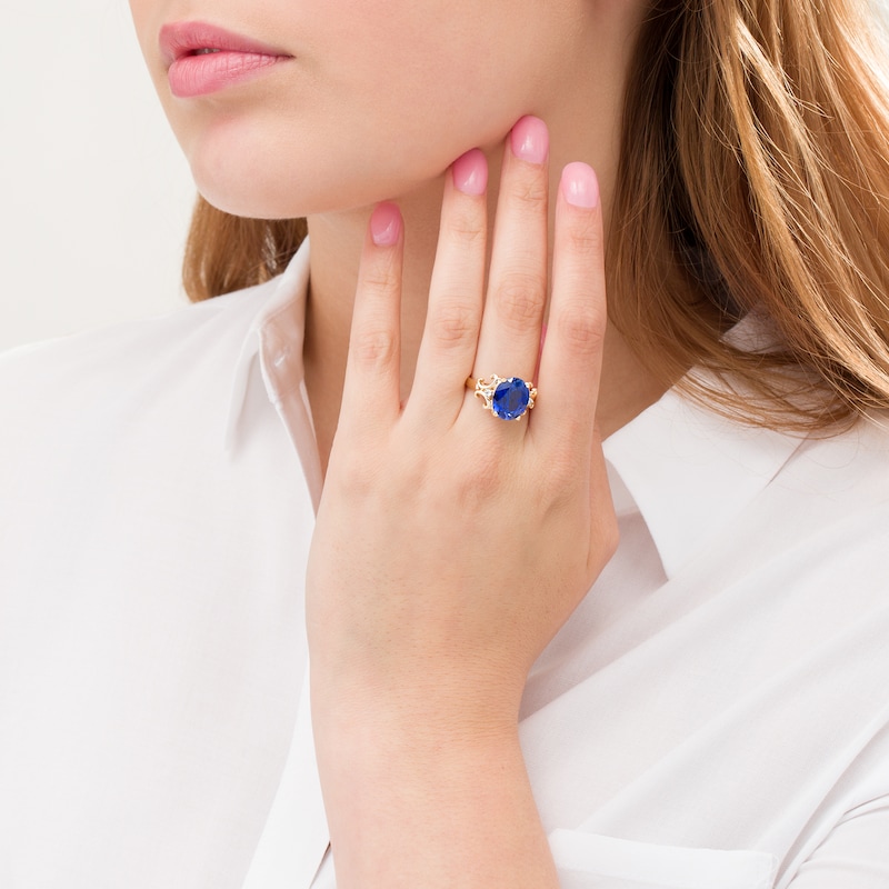 Main Image 2 of Oval Lab-Created Blue Sapphire and 1/20 CT. T.W. Diamond Scroll Frame Ring in 10K Gold