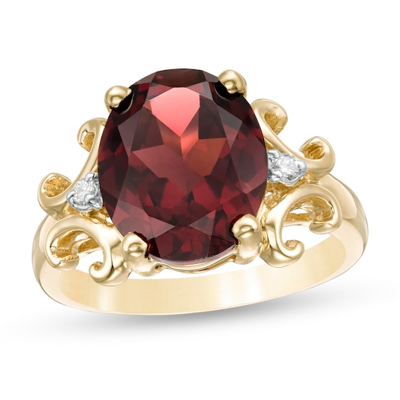 Oval Garnet and 1/20 CT. T.w. Diamond Scroll Frame Ring in 10K Gold