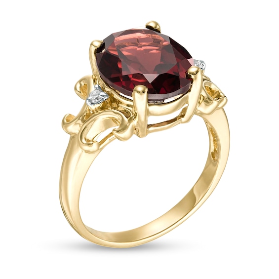 Oval Garnet and 1/20 CT. T.w. Diamond Scroll Frame Ring in 10K Gold