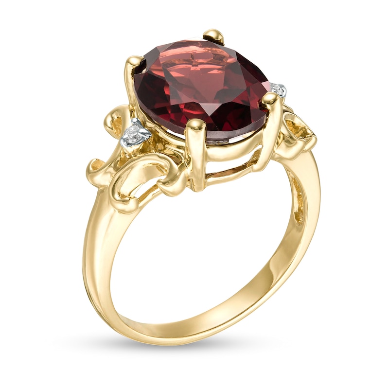 Oval Garnet and 1/20 CT. T.W. Diamond Scroll Frame Ring in 10K Gold