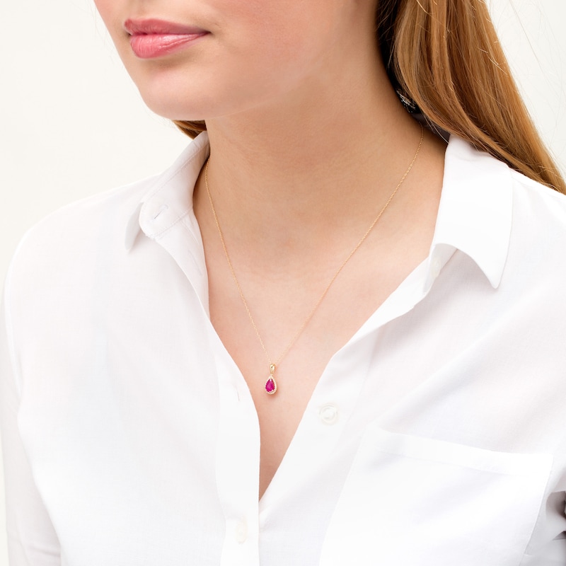 Main Image 2 of Pear-Shaped Ruby and 1/15 CT. T.W. Diamond Frame Pendant in 10K Gold