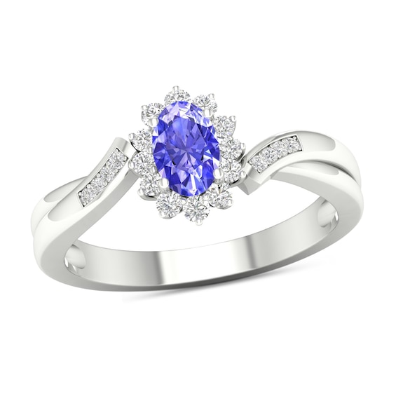 Oval Tanzanite and 1/8 CT. T.w. Diamond Sunburst Frame Twist Shank Ring in 10K White Gold