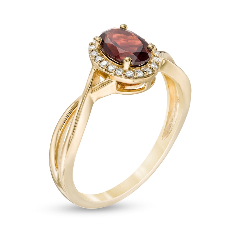 Oval Garnet and 1/15 CT. T.W. Diamond Frame Twist Shank Ring in 10K Gold