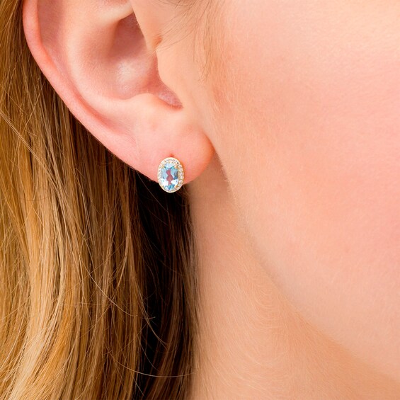 Oval Blue Topaz and 1/10 CT. T.w. Diamond Frame Stud Earrings in 10K Gold