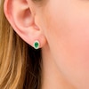 Thumbnail Image 1 of Oval Emerald and 1/10 CT. T.W. Diamond Frame Stud Earrings in 10K Gold