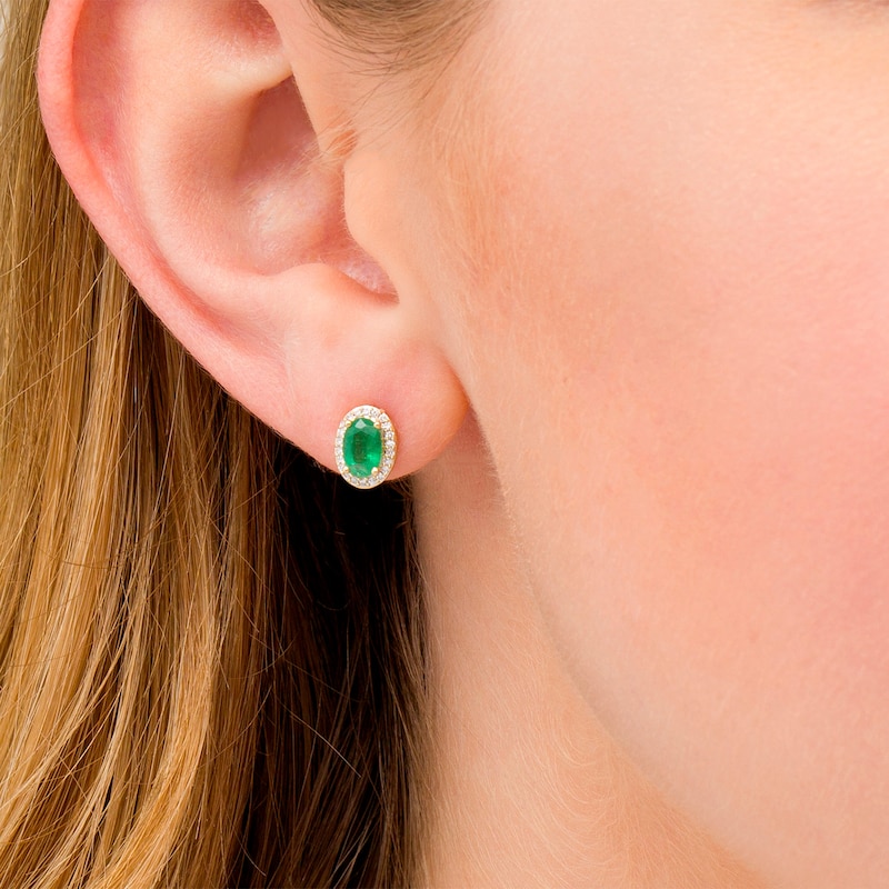 Oval Emerald and 1/10 CT. T.W. Diamond Frame Stud Earrings in 10K Gold