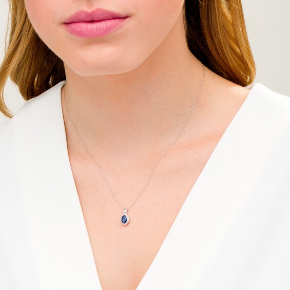 Oval Blue Sapphire and 1/15 CT. T.w. Diamond Frame Pendant in 10K White Gold