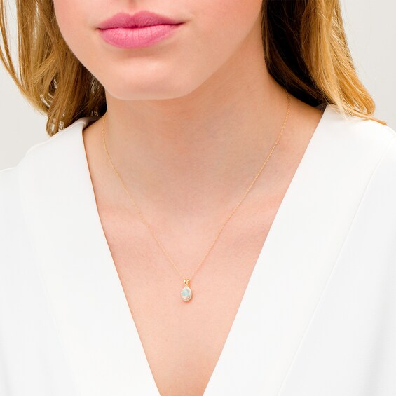 Oval Opal and 1/15 CT. T.w. Diamond Frame Pendant in 10K Gold