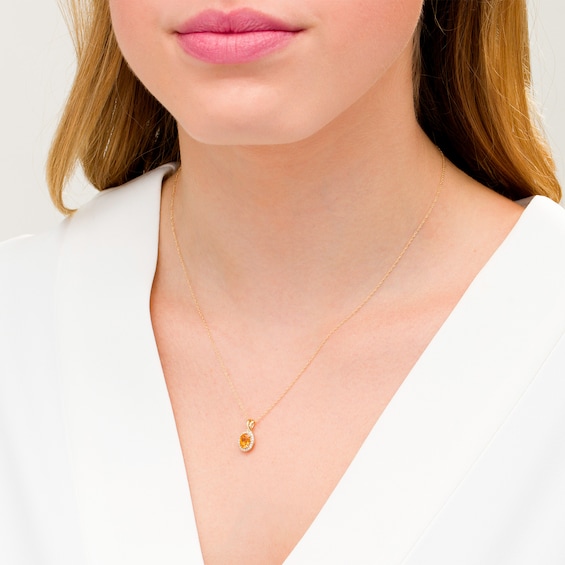 Oval Citrine and 1/15 CT. T.w. Diamond Frame Pendant in 10K Gold