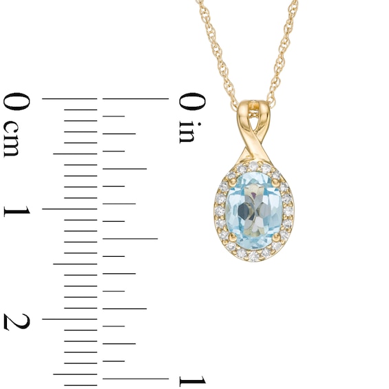 Oval Swiss Blue Topaz and 1/15 CT. T.w. Diamond Frame Pendant in 10K Gold