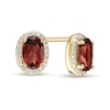 Thumbnail Image 0 of Oval Garnet and 1/10 CT. T.W. Diamond Frame Stud Earrings in 10K Gold