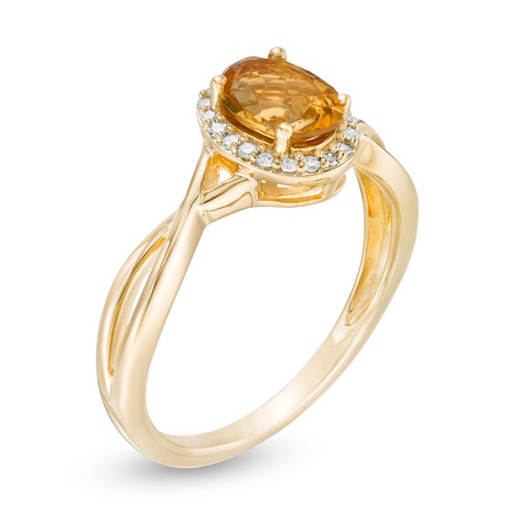 Oval Citrine and 1/15 CT. T.w. Diamond Frame Twist Shank Ring in 10K Gold