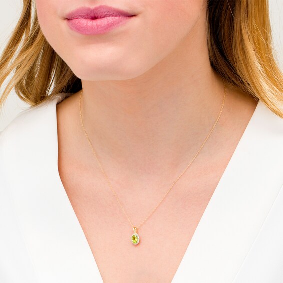 Oval Peridot and 1/15 CT. T.w. Diamond Frame Pendant in 10K Gold