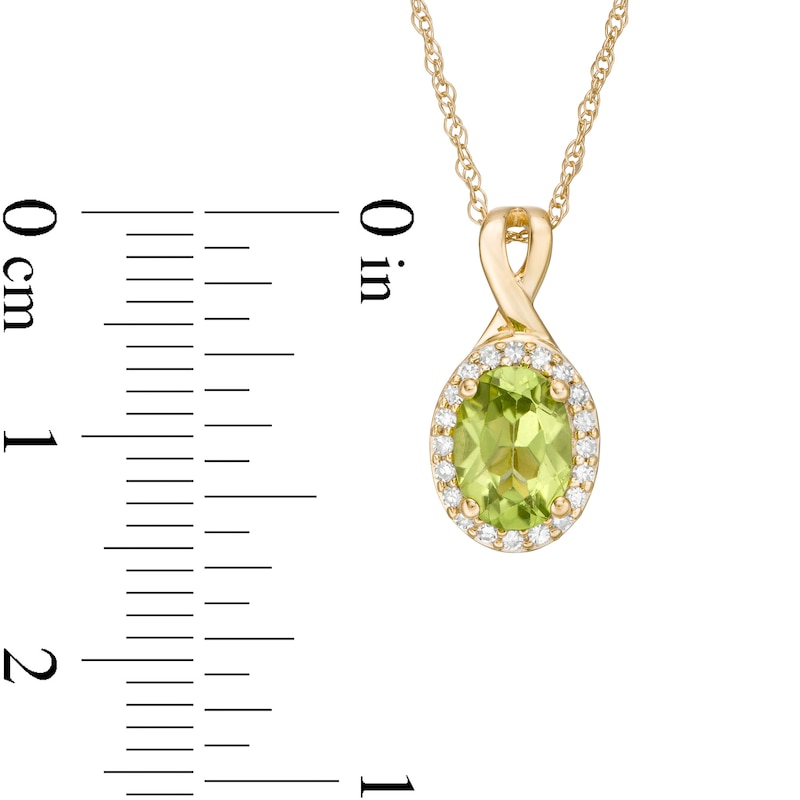 Oval Peridot and 1/15 CT. T.W. Diamond Frame Pendant in 10K Gold