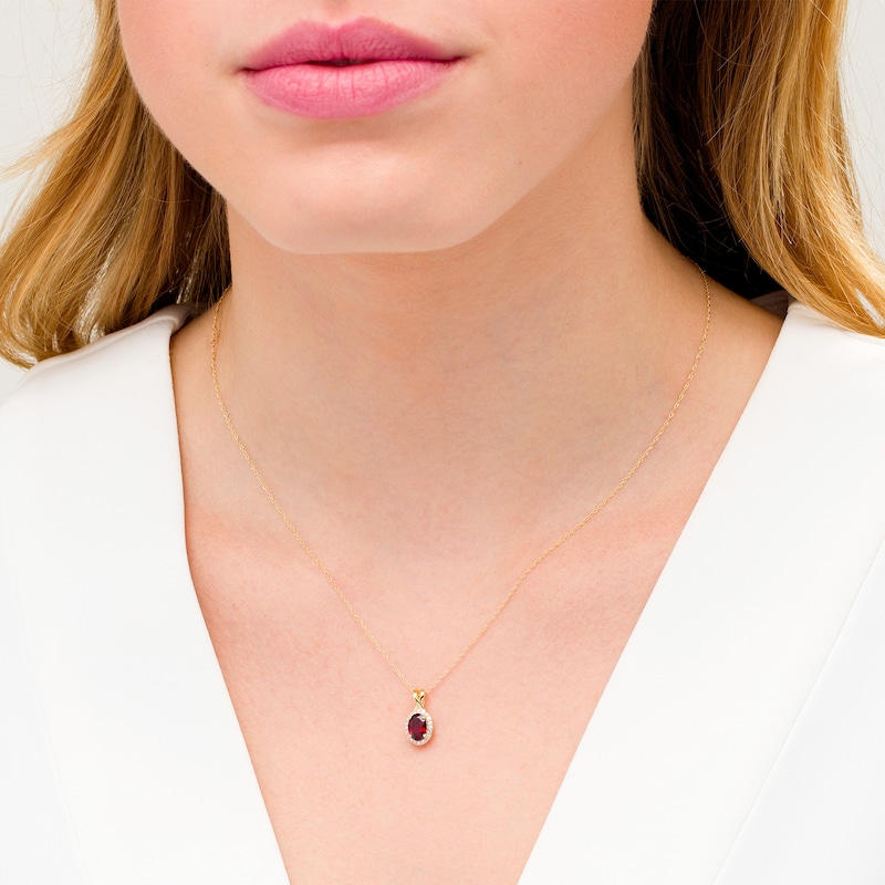 Main Image 2 of Oval Garnet and 1/15 CT. T.W. Diamond Frame Pendant in 10K Gold