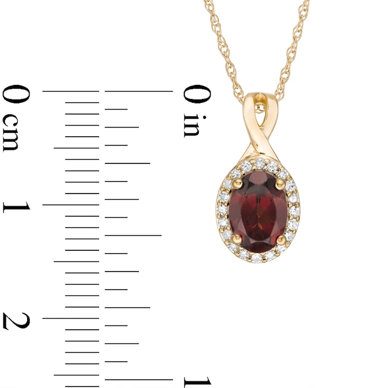 Oval Garnet and 1/15 CT. T.W. Diamond Frame Pendant in 10K Gold