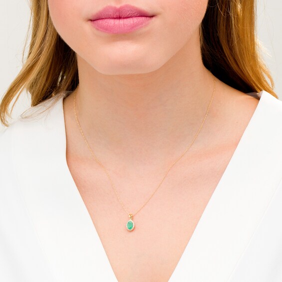Oval Emerald and 1/15 CT. T.w. Diamond Frame Pendant in 10K Gold
