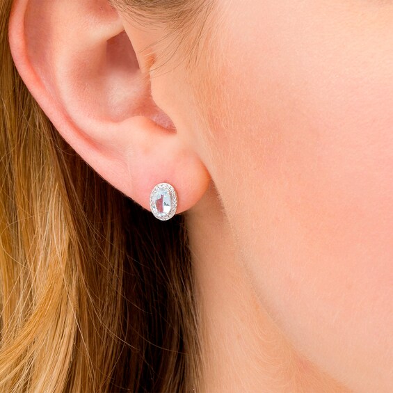 Oval Aquamarine and 1/10 CT. T.w. Diamond Frame Stud Earrings in 10K White Gold