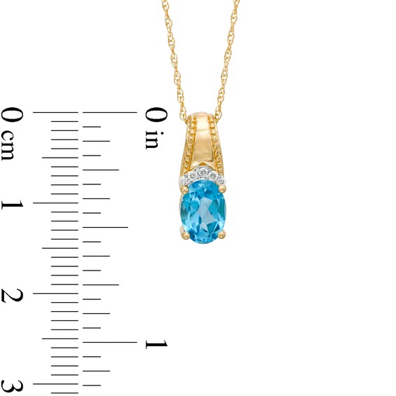 Oval Swiss Blue Topaz and Diamond Accent Beaded Drop Pendant in 10K Gold