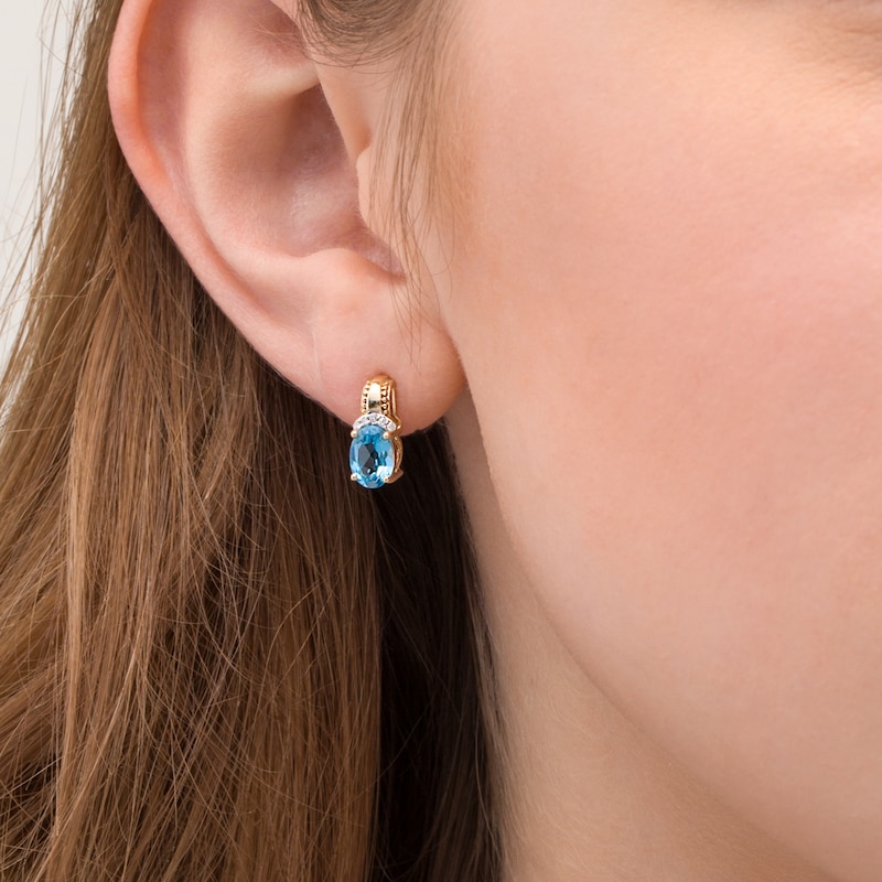 Oval Swiss Blue Topaz and 1/20 CT. T.W. Diamond Beaded Drop Earrings in 10K Gold