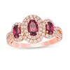 Thumbnail Image 1 of Oval Rhodolite Garnet and 1/2 CT. T.W. Diamond Frame Three Stone Engagement Ring in 14K Rose Gold