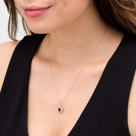 Oval Blue Sapphire and 1/5 CT. T.W. Baguette and Round Diamond Starburst Frame Pendant in 10K Gold Oval Blue Sapphire and 1/5 CT. T.W. Baguette and Round Diamond Starburst Frame Pendant in 10K Gold