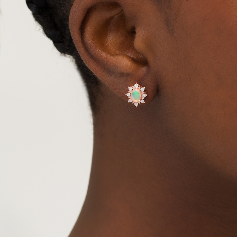 Main Image 2 of Oval Opal and 1/8 CT. T.W. Diamond Starburst Frame Vintage-Style Stud Earrings in 10K Rose Gold