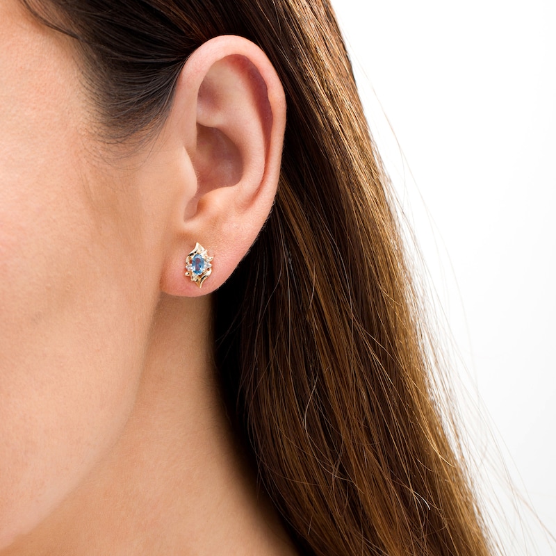 Oval Lab-Created Blue Zircon and Diamond Accent Flame Stud Earrings in 10K Gold