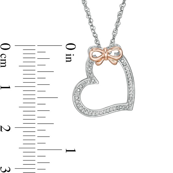 1/20 CT. T.w. Diamond Tilted Heart with Bow Pendant in Sterling Silver and 10K Rose Gold