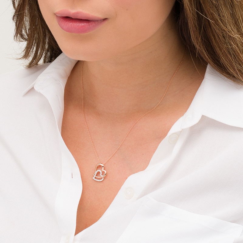Main Image 2 of 1/6 CT. T.W. Diamond Tilted Double Heart Pendant in 10K Two-Tone Gold