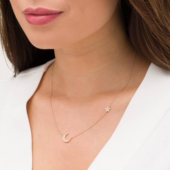 1/6 CT. T.w. Diamond Crescent Moon and Star Necklace in 10K Gold