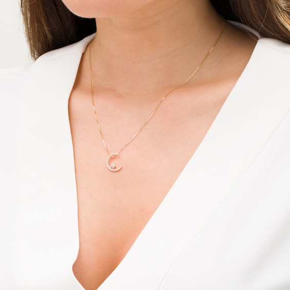 1/8 CT. T.w. Diamond Crescent Moon and Star Pendant in 10K Gold