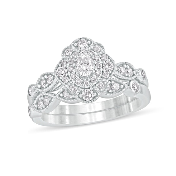 5/8 CT. T.w. Oval Diamond Double Petal Frame Vintage-Style Bridal Set in 10K White Gold
