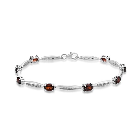 Oval Garnet and 1/6 CT. T.w. Diamond Link Bracelet in Sterling Silver - 7.25"
