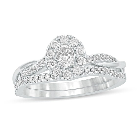 1/2 CT. T.w. Oval Diamond Frame Twist Shank Bridal Set in 10K White Gold