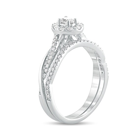 1/2 CT. T.w. Oval Diamond Frame Twist Shank Bridal Set in 10K White Gold