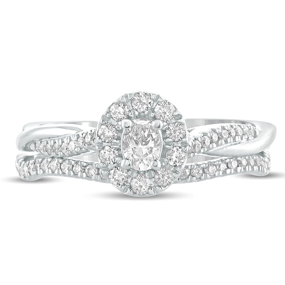 1/2 CT. T.w. Oval Diamond Frame Twist Shank Bridal Set in 10K White Gold