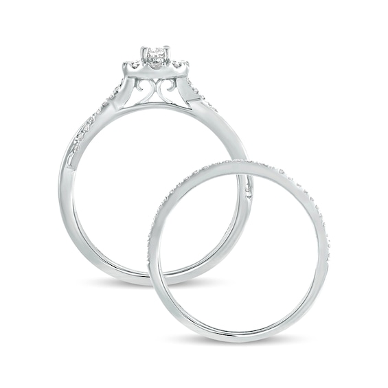 1/2 CT. T.w. Oval Diamond Frame Twist Shank Bridal Set in 10K White Gold
