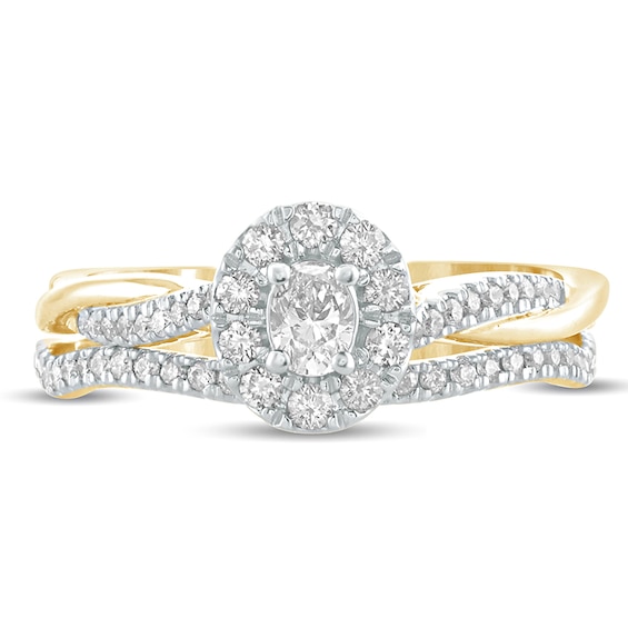 1/2 CT. T.w. Oval Diamond Frame Twist Shank Bridal Set in 10K Gold