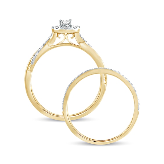 1/2 CT. T.w. Oval Diamond Frame Twist Shank Bridal Set in 10K Gold
