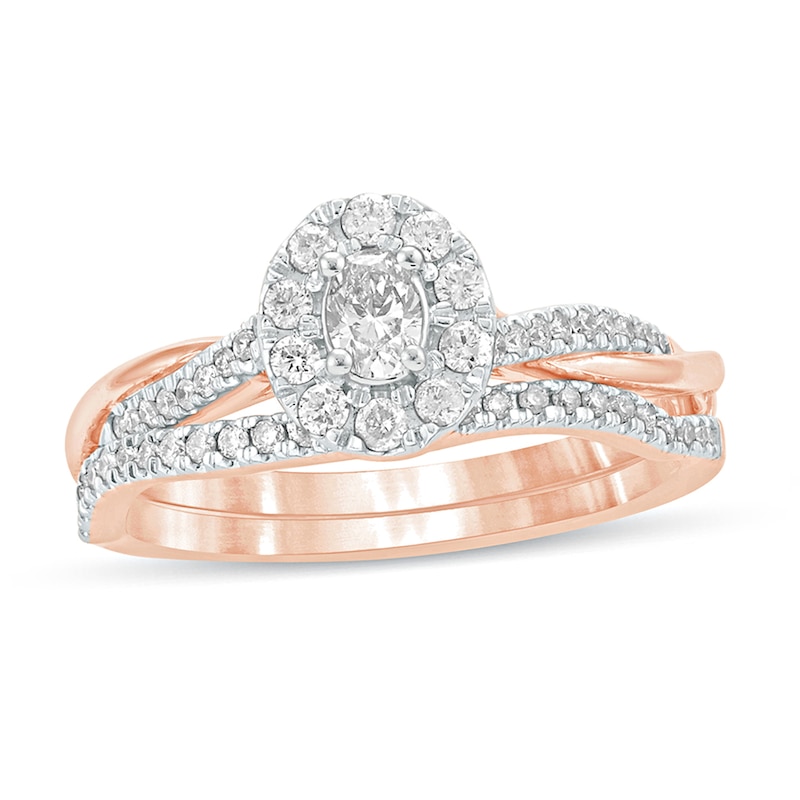 Main Image 1 of 1/2 CT. T.W. Oval Diamond Frame Twist Shank Bridal Set in 10K Rose Gold