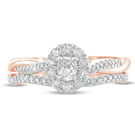 1/2 CT. T.w. Oval Diamond Frame Twist Shank Bridal Set in 10K Rose Gold
