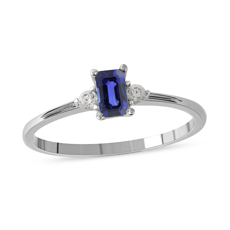 Main Image 1 of Emerald-Cut Blue Sapphire and 1/15 CT. T.W. Diamond Three Stone Grooved Ring in 10K White Gold