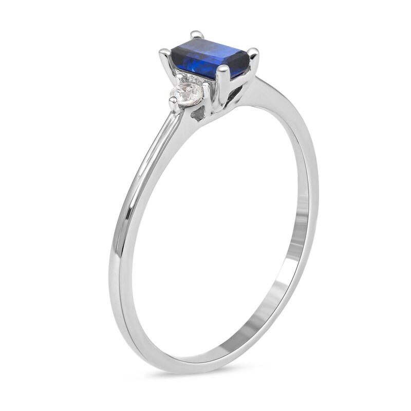 Main Image 2 of Emerald-Cut Blue Sapphire and 1/15 CT. T.W. Diamond Three Stone Grooved Ring in 10K White Gold
