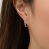 Thumbnail Image 2 of 1/10 CT. T.W. Diamond Twist Huggie Hoop Earrings in 10K Gold