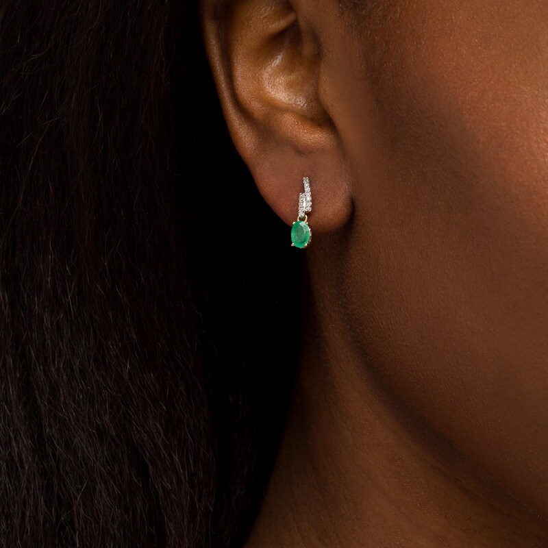 Main Image 2 of Oval Emerald and 1/6 CT. T.W. Diamond Bypass Ribbon Loop Drop Earrings in 10K Gold